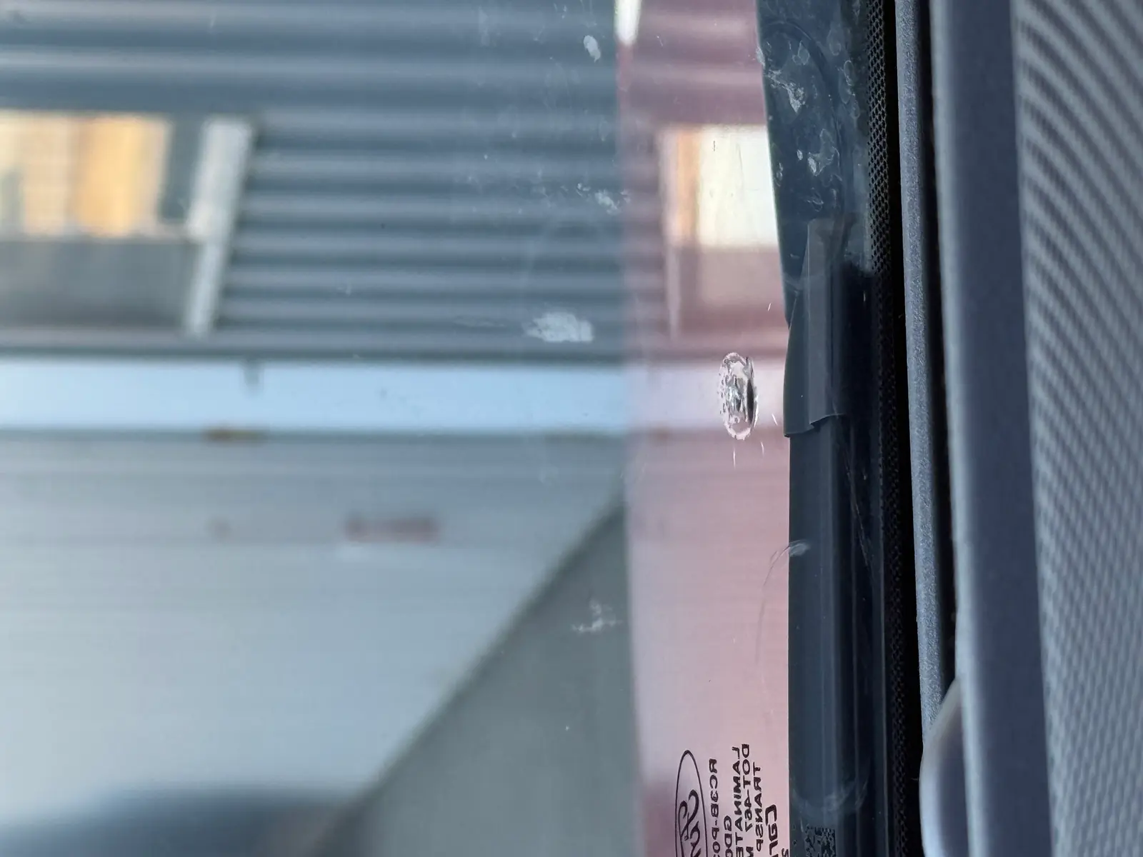 Close-up of a windshield chip before repair