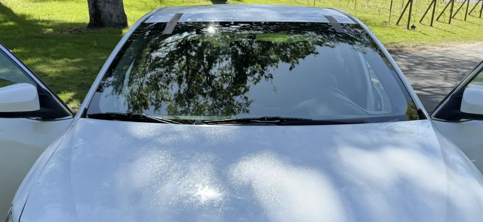 Fresh windshield installation on a white vehicle in Roseville